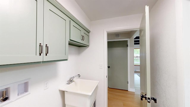 801 S Maryknoll Ave, Marshfield, WI 54449 - laundry room featuring cabinet space, hookup for a washing machine, and light wood-type flooring