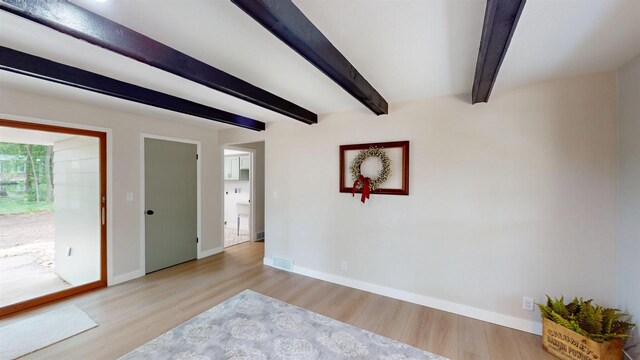 801 S Maryknoll Ave, Marshfield, WI 54449 - spare room featuring wood finished floors and beam ceiling