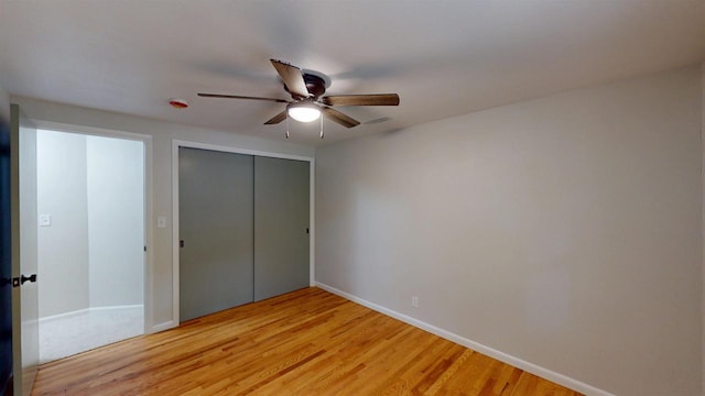 801 S Maryknoll Ave, Marshfield, WI 54449 - unfurnished bedroom featuring a closet, light wood finished floors, and a ceiling fan