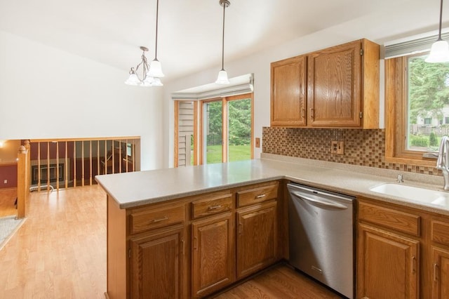5947 Pilgrim Way, Mount Pleasant, WI 53406 - kitchen with dishwasher, decorative backsplash, light countertops, and a peninsula