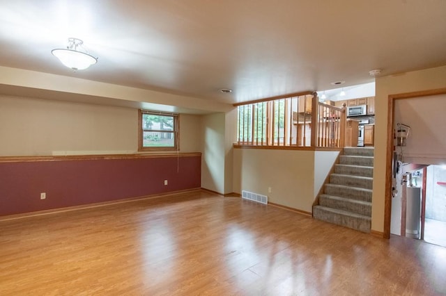 5947 Pilgrim Way, Mount Pleasant, WI 53406 - below grade area with light wood-style floors and stairway