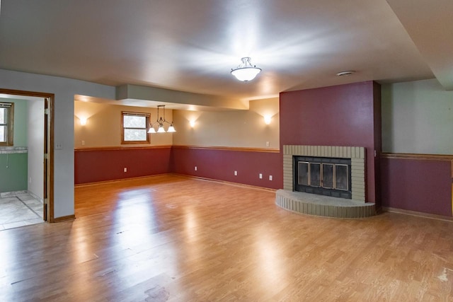 5947 Pilgrim Way, Mount Pleasant, WI 53406 - unfurnished living room with a fireplace and wood finished floors