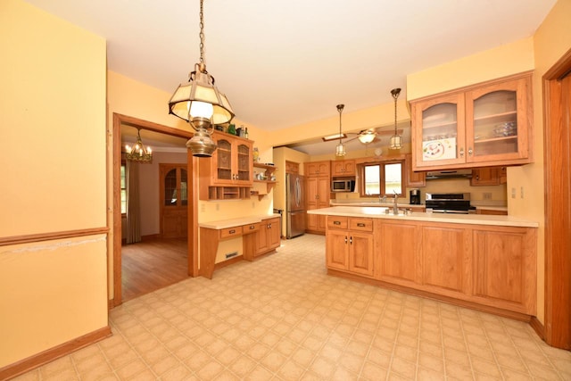 3786 S 35th St, Greenfield, WI 53221 - kitchen featuring stainless steel appliances, under cabinet range hood, light countertops, a peninsula, and glass insert cabinets