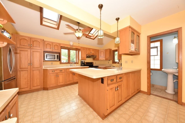 3786 S 35th St, Greenfield, WI 53221 - kitchen featuring appliances with stainless steel finishes, under cabinet range hood, a skylight, light floors, and light countertops