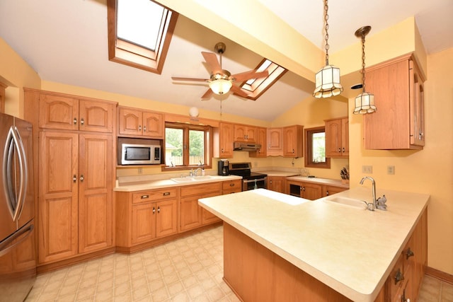 3786 S 35th St, Greenfield, WI 53221 - kitchen with a skylight, stainless steel appliances, under cabinet range hood, a peninsula, and light countertops
