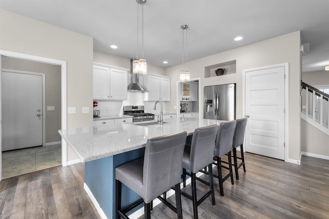 405 Blue Moon Dr, Verona, WI 53593 - kitchen with appliances with stainless steel finishes, wall chimney range hood, white cabinets, a breakfast bar, and dark wood-style floors