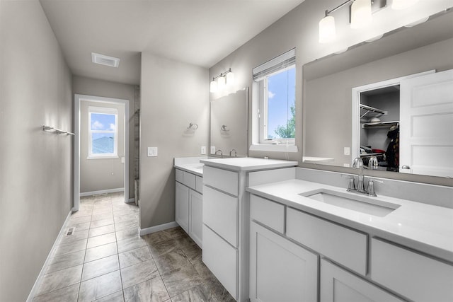 405 Blue Moon Dr, Verona, WI 53593 - bathroom with plenty of natural light, two vanities, marble finish floors, and a spacious closet