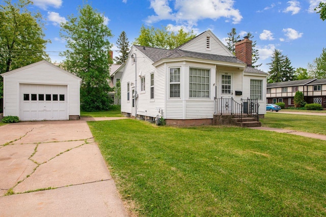 120 W 12th St, Ashland, WI 54806 - view of front of home featuring an outdoor structure, a garage, a chimney, and a front yard