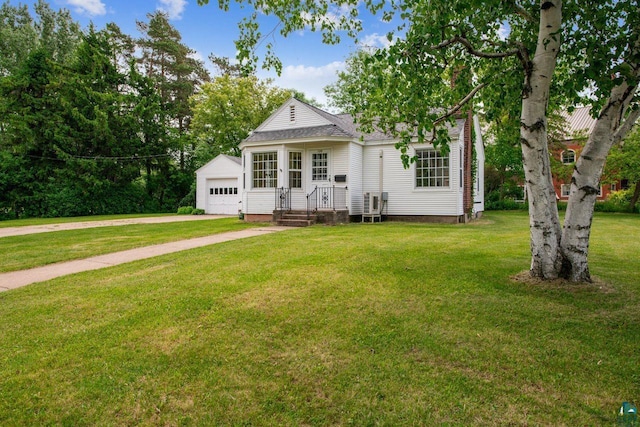 120 W 12th St, Ashland, WI 54806 - view of front of home featuring a garage, a front lawn, driveway, an outdoor structure, and a shingled roof