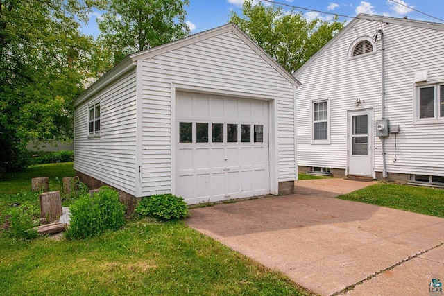 120 W 12th St, Ashland, WI 54806 - view of front facade featuring a garage, driveway, and an outbuilding