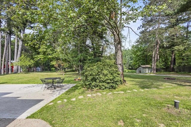 175 Old Wausau Rd, Stevens Point, WI 54481 - view of yard featuring a patio area, a storage shed, a fire pit, and view of scattered trees