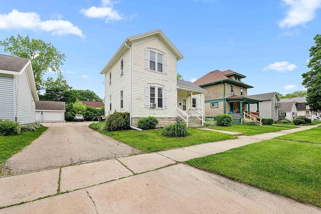 274 E 1st St, Fond Du Lac, WI 54935 - view of front of house featuring a front yard, a garage, and covered porch