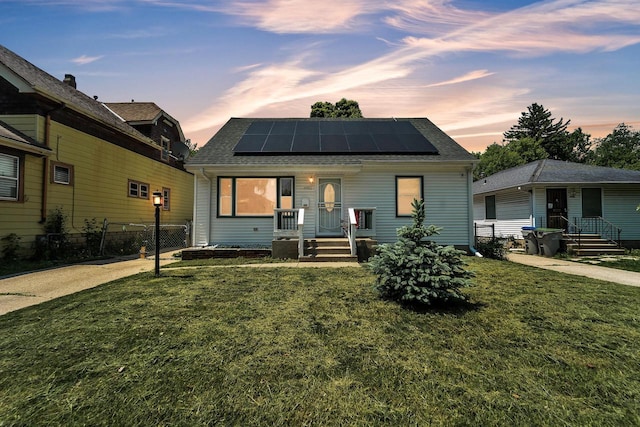 4951 N 49th St, Milwaukee, WI 53218 - view of front facade featuring solar panels, a shingled roof, and covered porch
