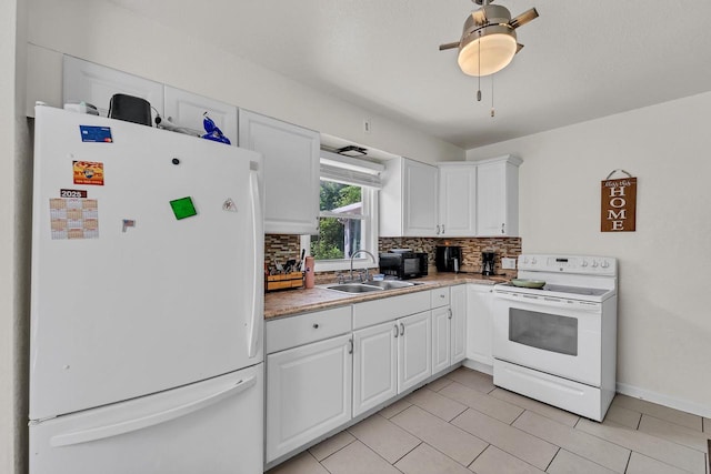 4951 N 49th St, Milwaukee, WI 53218 - kitchen with white appliances, tasteful backsplash, white cabinets, and light countertops