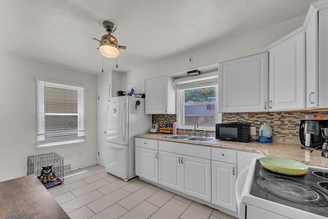 4951 N 49th St, Milwaukee, WI 53218 - kitchen featuring white appliances, decorative backsplash, white cabinetry, light countertops, and ceiling fan