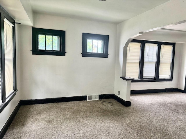 4668 N 29th St, Milwaukee, WI 53209 - unfurnished room featuring carpet, plenty of natural light, and arched walkways