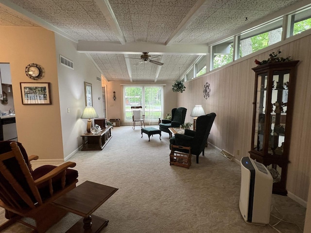 1011 19th Ave S, Wisconsin Rapids, WI 54495 - living area with carpet, a ceiling fan, beam ceiling, and wood walls