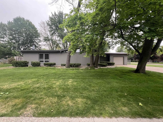1011 19th Ave S, Wisconsin Rapids, WI 54495 - view of front of home featuring a front yard, an attached garage, and concrete driveway