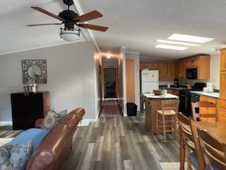1116 Fawn Dr, Grand Marsh, WI 53936 - kitchen featuring black microwave, freestanding refrigerator, dark wood finished floors, a kitchen island, and lofted ceiling