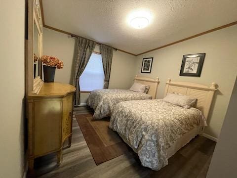 1116 Fawn Dr, Grand Marsh, WI 53936 - bedroom with a textured ceiling, ornamental molding, and dark wood-type flooring