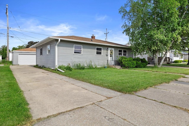 1708 Shoop St, Racine, WI 53404 - view of front facade featuring a garage, an outdoor structure, a front lawn, a chimney, and roof with shingles