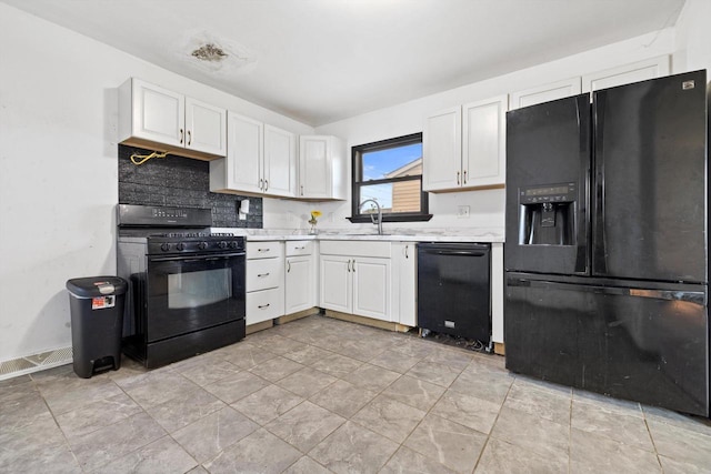 1708 Shoop St, Racine, WI 53404 - kitchen with black appliances, light countertops, white cabinets, and backsplash
