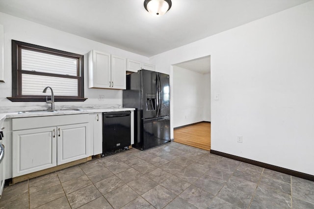 1708 Shoop St, Racine, WI 53404 - kitchen with black appliances, white cabinetry, and stone finish flooring