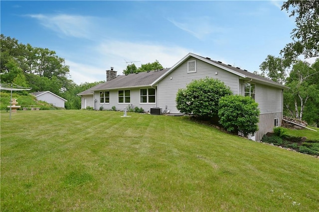 5342 W County Highway F, Trego, WI 54888 - back of property with a chimney and a yard