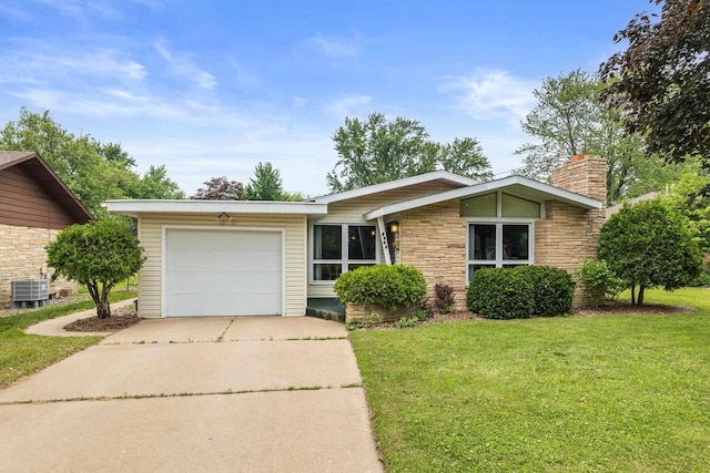 2908 Prais St, Stevens Point, WI 54481 - view of front of property featuring driveway, an attached garage, stone siding, and a front lawn