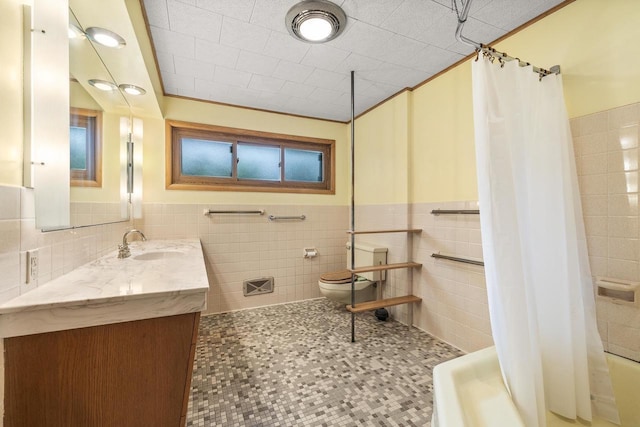 2908 Prais St, Stevens Point, WI 54481 - bathroom featuring tile walls, vanity, a wainscoted wall, and shower / bath combo with shower curtain