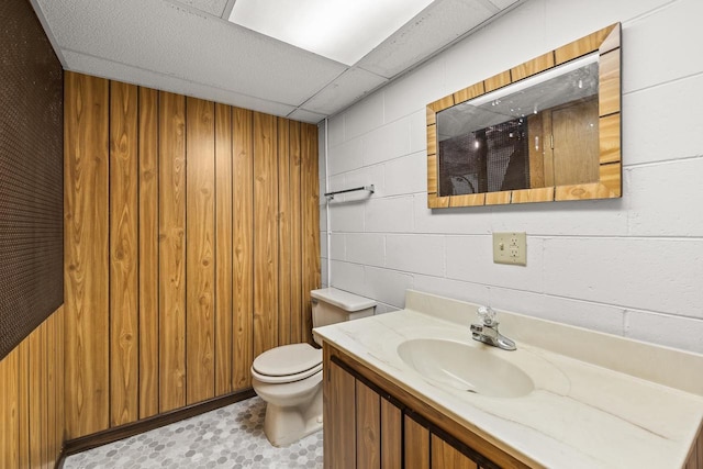 2908 Prais St, Stevens Point, WI 54481 - bathroom featuring vanity, wood walls, and tile patterned floors