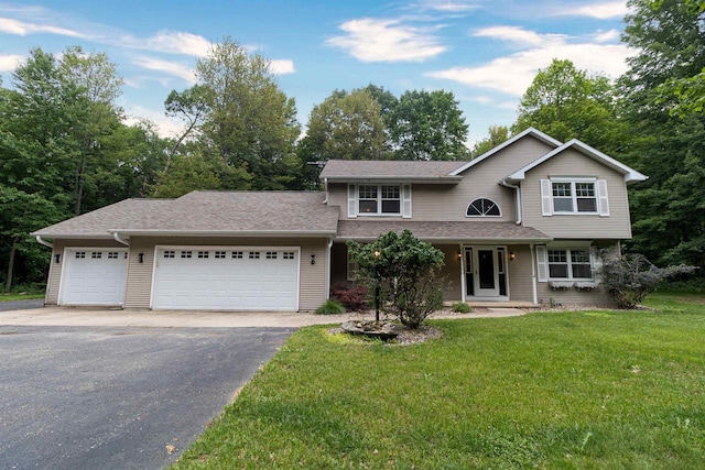 N2559 Pleasant View Ln, Waupaca, WI 54981 - view of front of house with asphalt driveway, a garage, a front yard, and roof with shingles