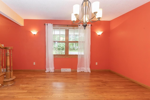 N2559 Pleasant View Ln, Waupaca, WI 54981 - spare room featuring a chandelier and light wood-type flooring