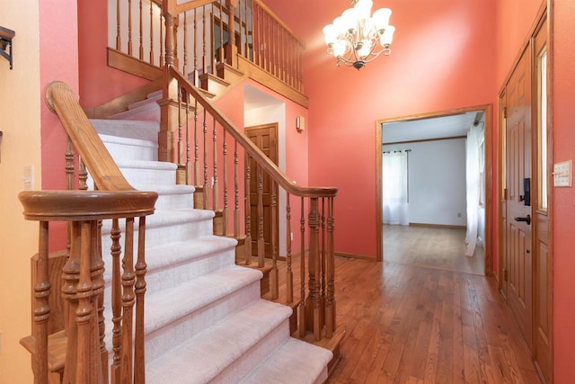 N2559 Pleasant View Ln, Waupaca, WI 54981 - foyer featuring hardwood / wood-style floors, a towering ceiling, a chandelier, and stairs