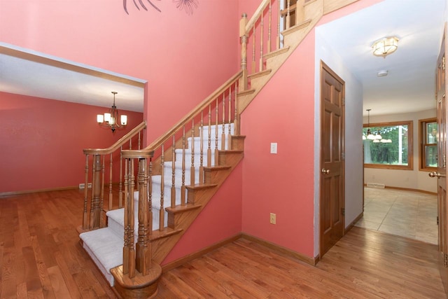 N2559 Pleasant View Ln, Waupaca, WI 54981 - staircase featuring a chandelier and wood finished floors