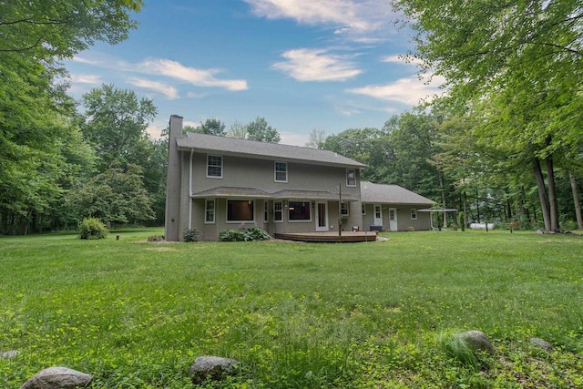 N2559 Pleasant View Ln, Waupaca, WI 54981 - rear view of property featuring a chimney, a yard, and a wooden deck