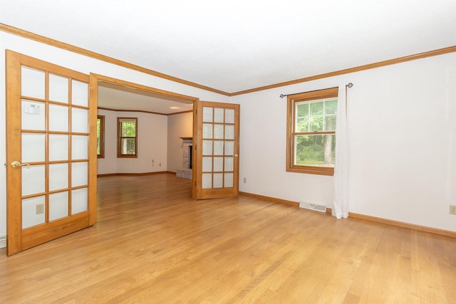 N2559 Pleasant View Ln, Waupaca, WI 54981 - unfurnished room featuring ornamental molding, french doors, light wood-style flooring, and plenty of natural light