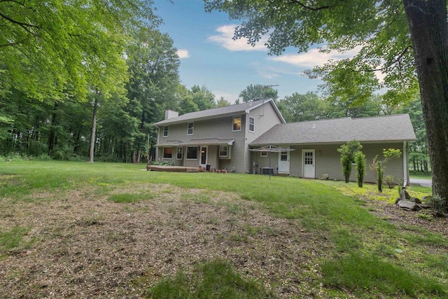N2559 Pleasant View Ln, Waupaca, WI 54981 - rear view of property featuring a lawn, a chimney, and a deck
