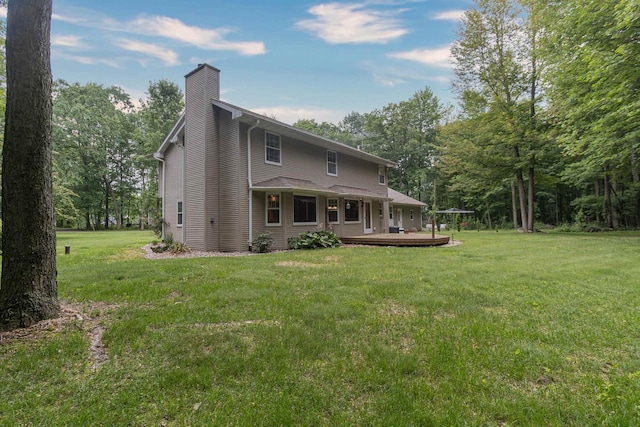 N2559 Pleasant View Ln, Waupaca, WI 54981 - back of property featuring a chimney, a wooden deck, and a lawn