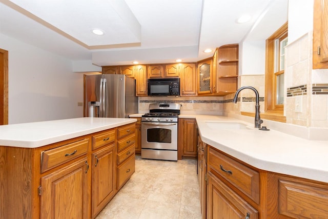 N2559 Pleasant View Ln, Waupaca, WI 54981 - kitchen featuring stainless steel appliances, brown cabinets, tasteful backsplash, a tray ceiling, and recessed lighting