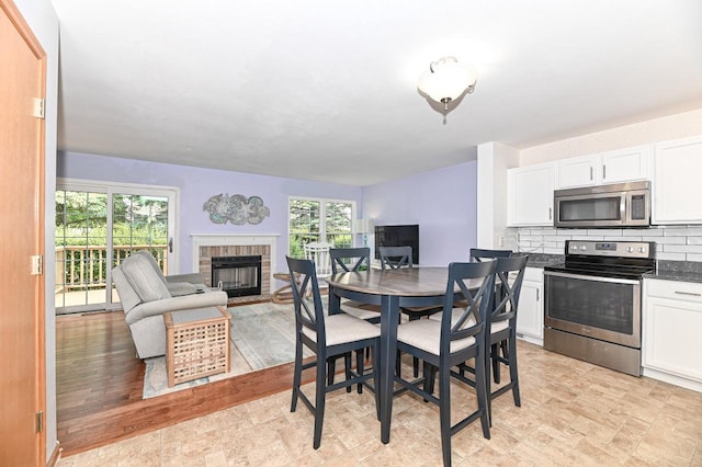 2147 E Broadway Unit A, Waukesha, WI 53186 - dining area with a fireplace, plenty of natural light, and stone finish flooring