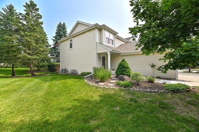 2147 E Broadway Unit A, Waukesha, WI 53186 - view of property exterior with a yard and a cooling unit