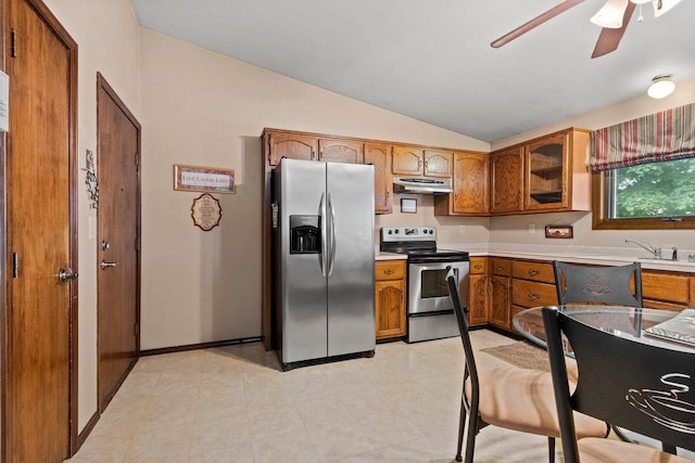 2409 Cedar Ridge Ct Unit D, Green Bay, WI 54313 - kitchen with stainless steel appliances, brown cabinetry, under cabinet range hood, lofted ceiling, and ceiling fan
