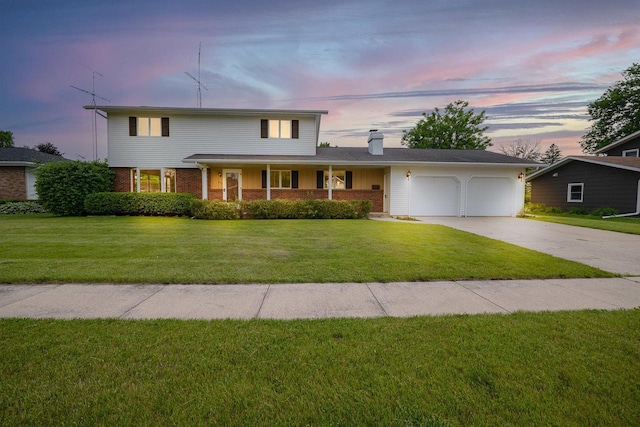 614 8th St, Fond Du Lac, WI 54935 - traditional home with an attached garage, a chimney, driveway, brick siding, and a front yard