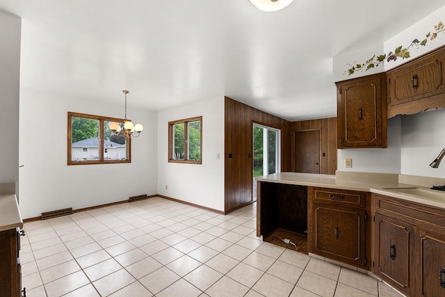 614 8th St, Fond Du Lac, WI 54935 - kitchen featuring healthy amount of natural light, light countertops, a chandelier, and a peninsula