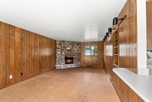 614 8th St, Fond Du Lac, WI 54935 - unfurnished living room featuring wood walls, a fireplace, and a barn door