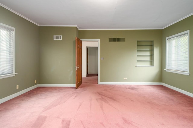 645 Wisconsin St, Oshkosh, WI 54901 - carpeted spare room featuring crown molding and built in features