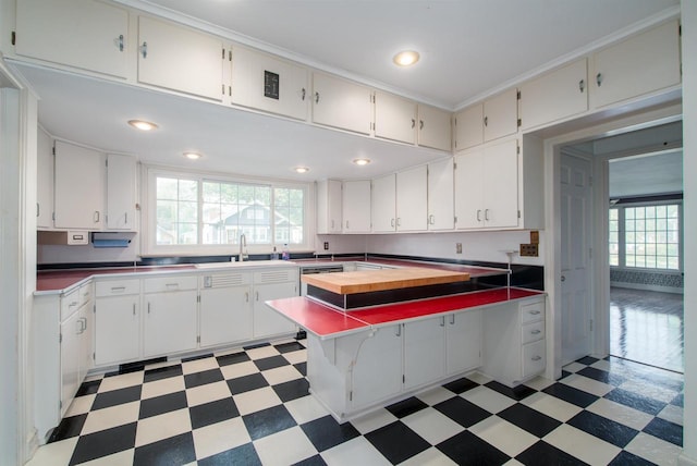 645 Wisconsin St, Oshkosh, WI 54901 - kitchen with light floors, healthy amount of natural light, white cabinetry, and recessed lighting