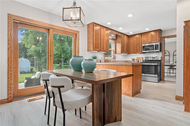 3203 Canterbury Cir, Saint Paul, MN 55125 - kitchen featuring stainless steel appliances, a chandelier, plenty of natural light, light wood-type flooring, and recessed lighting