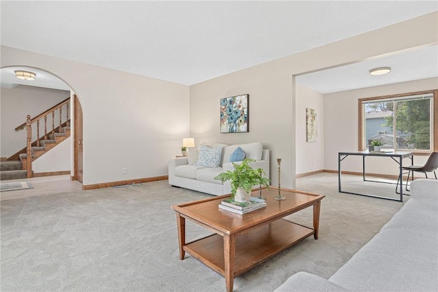 3203 Canterbury Cir, Saint Paul, MN 55125 - living room with light colored carpet, stairs, and arched walkways